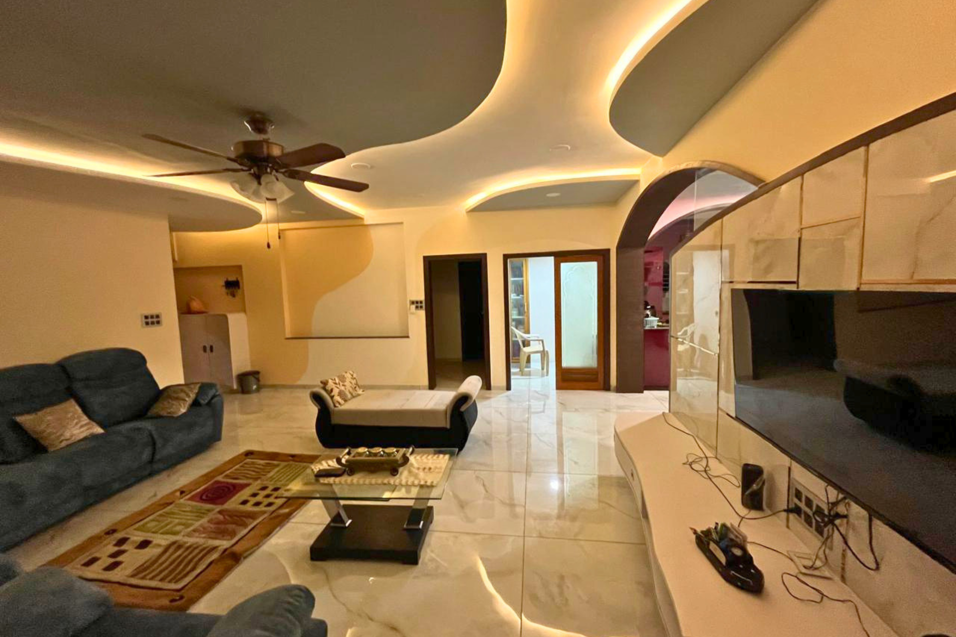 Fluid ceiling design living room 4BHK residence interior Ahmedabad